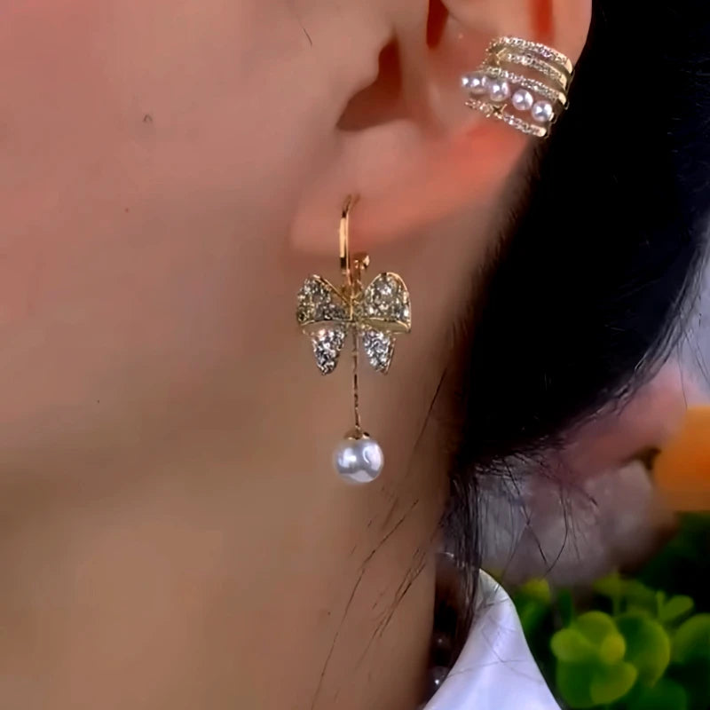Model showcasing the dangle and style of the 14K Gold-Plated Zircon Butterfly Cat's Eye Stone Pearl Earrings