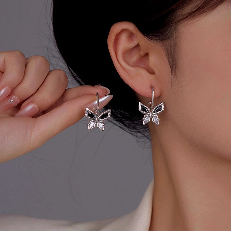 Model showcasing the dangle and style of the 14K Gold-Plated Zircon Butterfly Earrings
