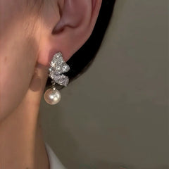 Model showcasing the dangle and style of the 14K Gold-Plated Zircon Butterfly Pearl Earrings