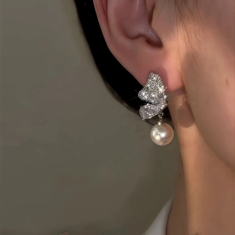 Close-up detail of the sparkling zircons and plating on the Butterfly Pearl Earrings