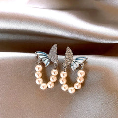Angled view of the 14K Gold-Plated Zircon Butterfly Pearl Earrings