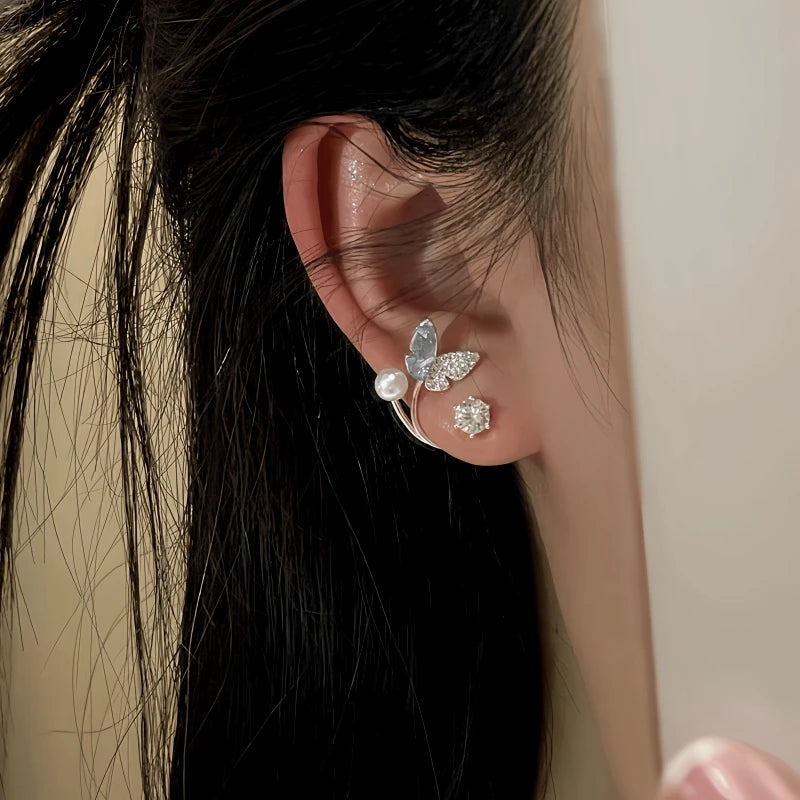 Model showcasing the dangle and style of the 14K Gold-Plated Zircon Butterfly Pearl Jacket Earrings