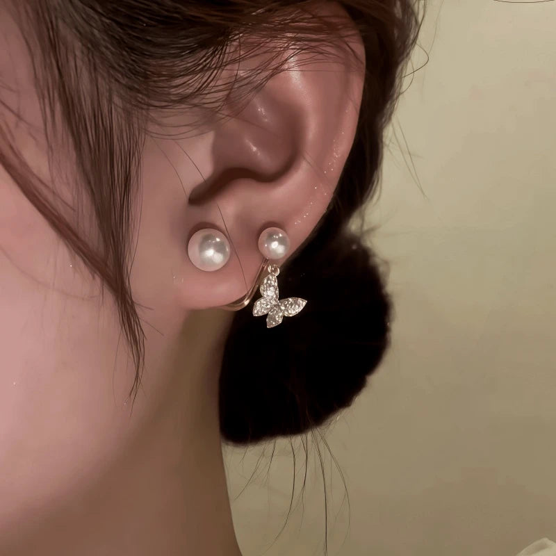 Model showcasing the dangle and style of the 14K Gold-Plated Zircon Butterfly Pearl Jacket Earrings