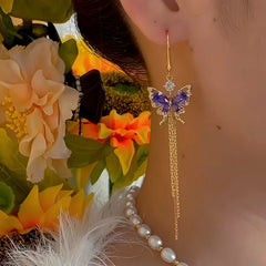 Angled view of the 14K Gold-Plated Zircon Butterfly Tassel Earrings