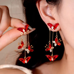 Model showcasing the dangle and style of the 14K Gold-Plated Zircon Butterfly Tassel Earrings