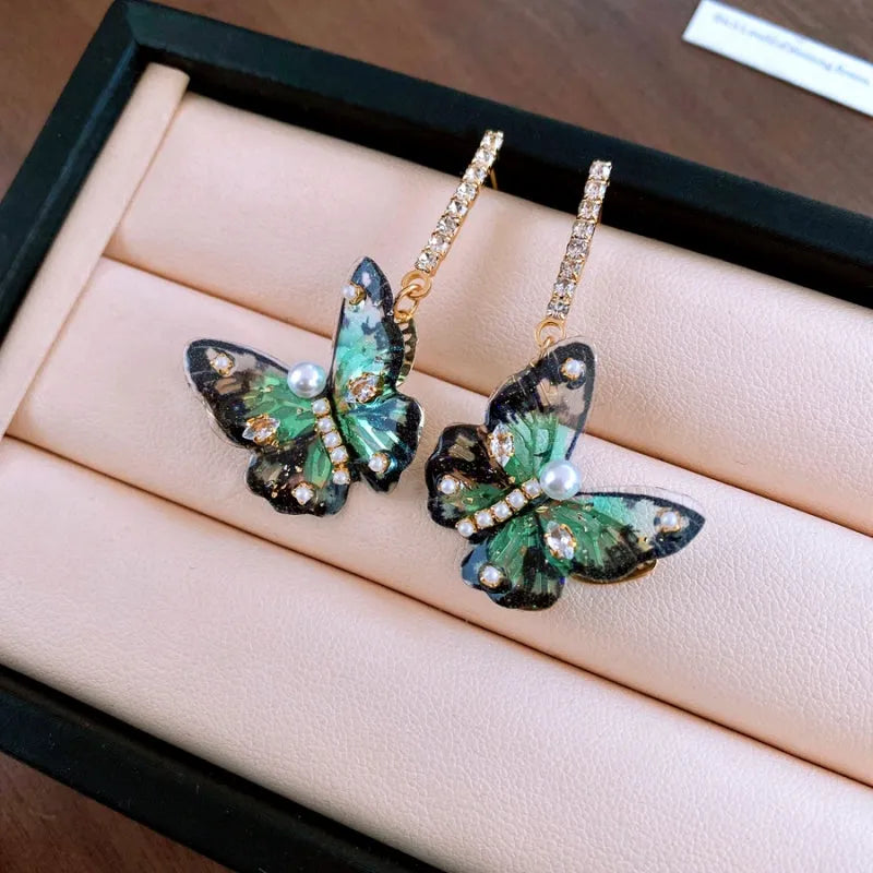 Close-up detail of the sparkling zircons and plating on the Green Butterfly Earrings