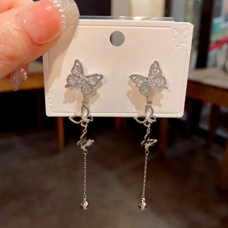 Model showcasing the dangle and style of the 14K Gold-Plated Zircon Butterfly Tassel Earrings