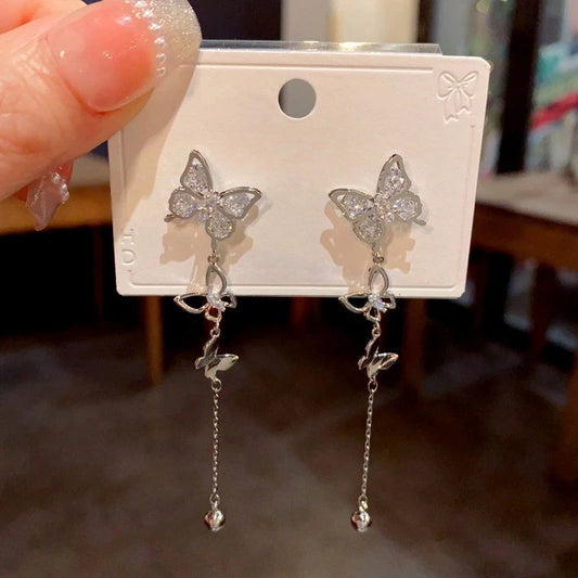 Model showcasing the dangle and style of the 14K Gold-Plated Zircon Butterfly Tassel Earrings