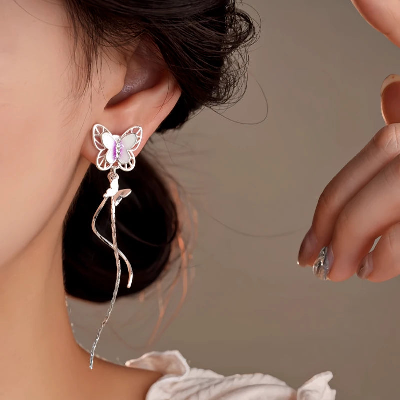 Model showcasing the dangle and style of the 14K Gold-Plated Zircon Butterfly Tassel Earrings