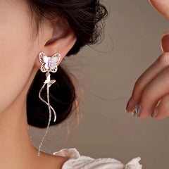 Model showcasing the dangle and style of the 14K Gold-Plated Zircon Butterfly Tassel Earrings