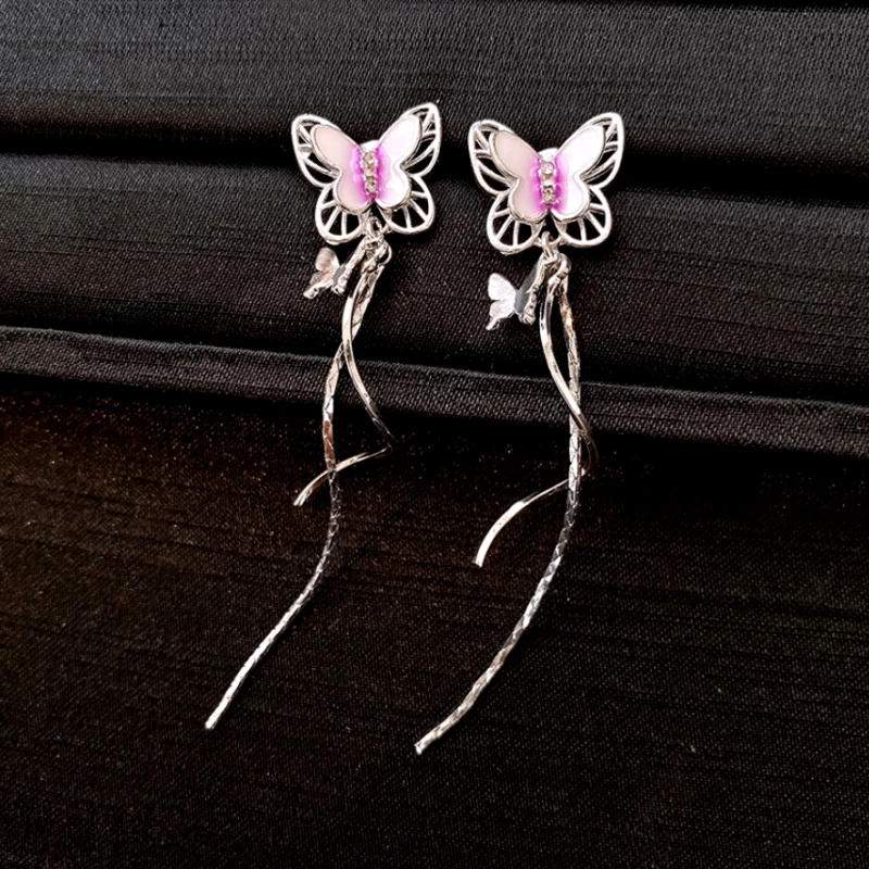 Angled view of the 14K Gold-Plated Zircon Butterfly Tassel Earrings