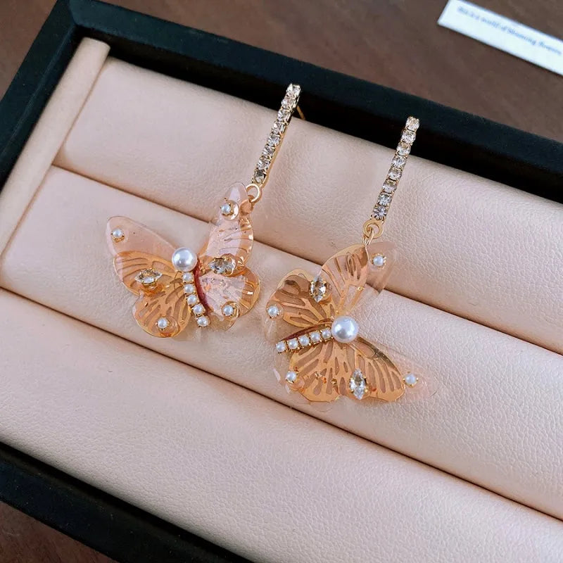 Angled view of the 14K Gold-Plated Zircon Butterfly Tassel Earrings
