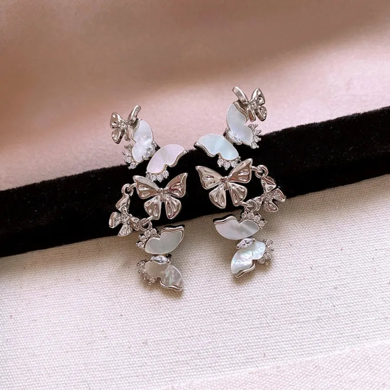 Angled view of the 14K Gold-Plated Zircon Butterfly Tassel Earrings