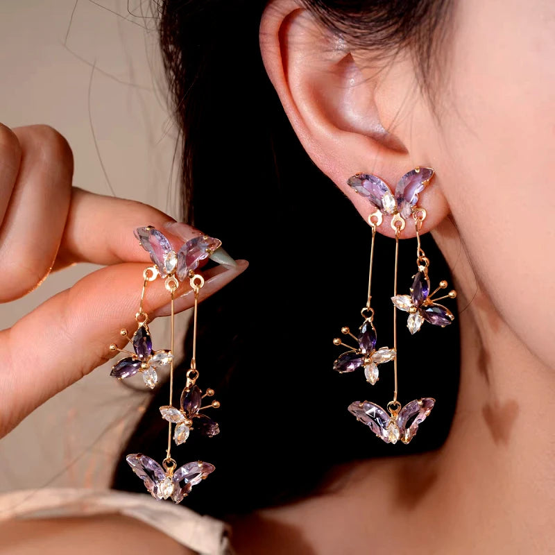 Angled view of the 14K Gold-Plated Zircon Butterfly Tassel Earrings