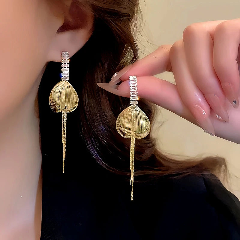 Model showcasing the dangle and style of the 14K Gold-Plated Zircon Butterfly Wing Tassel Earrings