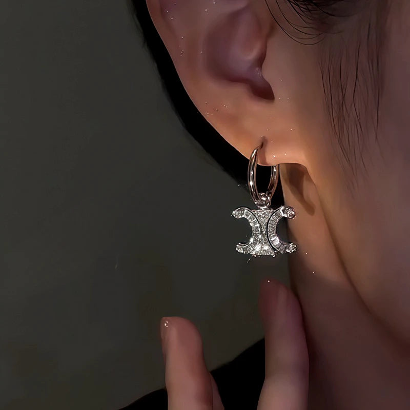 Model showcasing the dangle and style of the 14K Gold-Plated Zircon C-Shaped Earrings