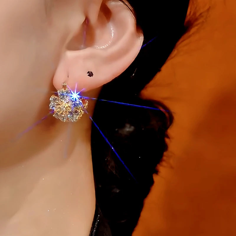 Model showcasing the dangle and style of the 14K Gold-Plated Zircon Cat's Eye Double-Sided Flower Earrings