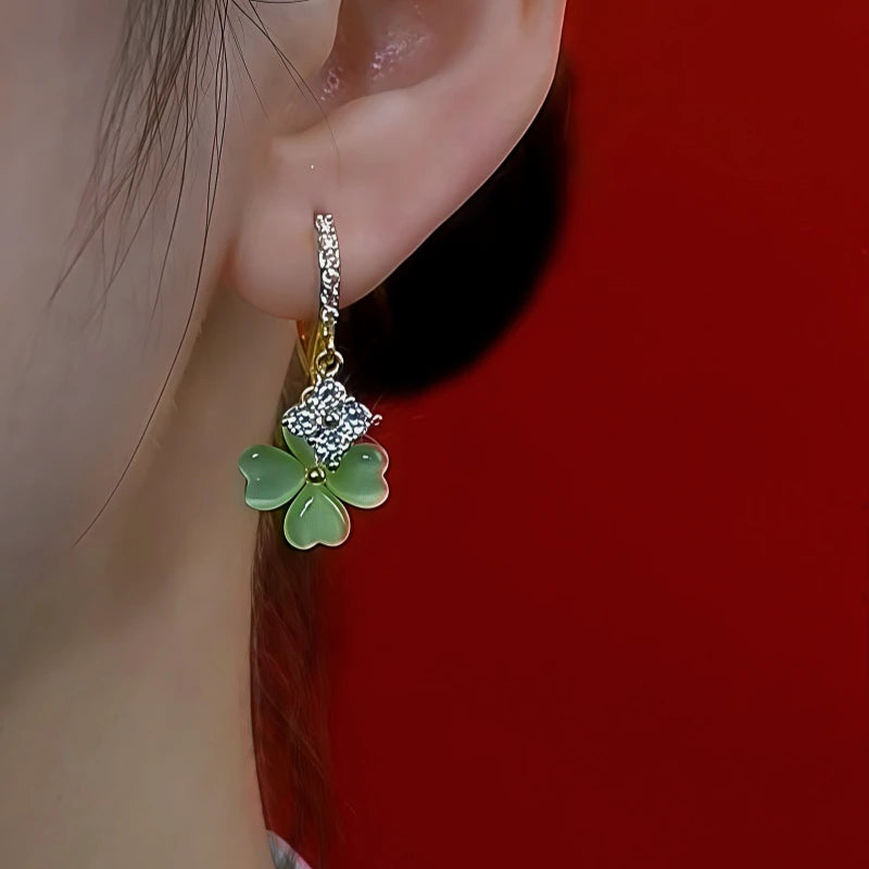 Model showcasing the dangle and style of the 14K Gold-Plated Zircon Cat's Eye Four Leaf Earrings
