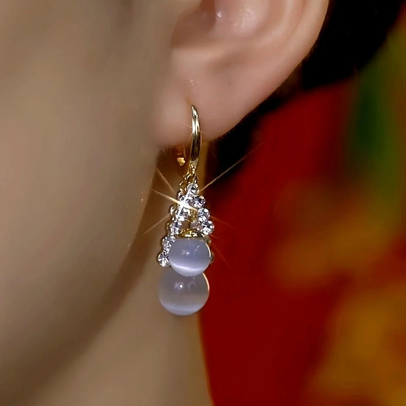 Close-up detail of the sparkling zircons and plating on the Cat's Eye Drop Earrings