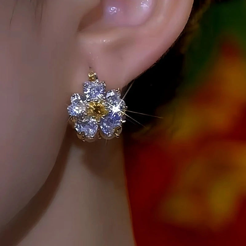 Model showcasing the dangle and style of the 14K Gold-Plated Zircon Cat's Eye Stone Flower Earrings