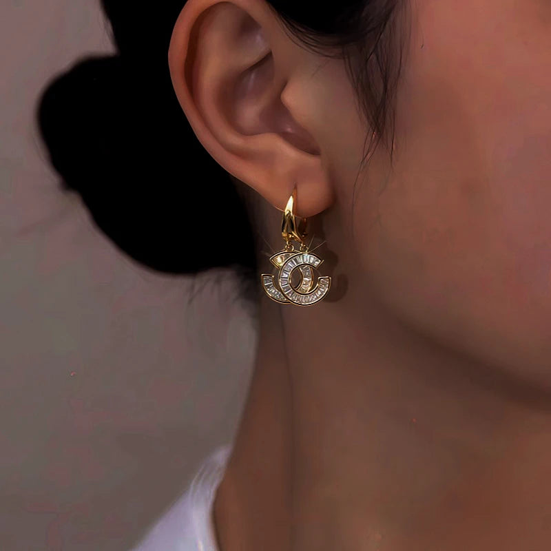 Close-up detail of the sparkling zircons and plating on the Double C Earrings