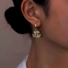 Close-up detail of the sparkling zircons and plating on the Double C Earrings