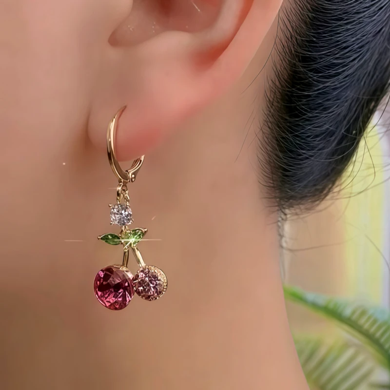 Model showcasing the dangle and style of the 14K Gold-Plated Zircon Cherry Earrings