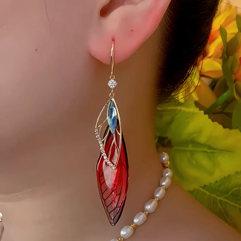 Model showcasing the dangle and style of the 14K Gold-Plated Zircon Colored Feather Earrings
