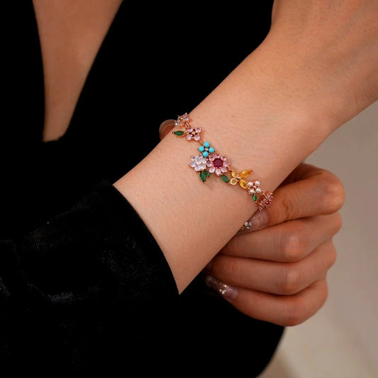 Model wearing the 14K Gold-Plated Zircon Colorful Flower Bracelet to highlight its design on the wrist