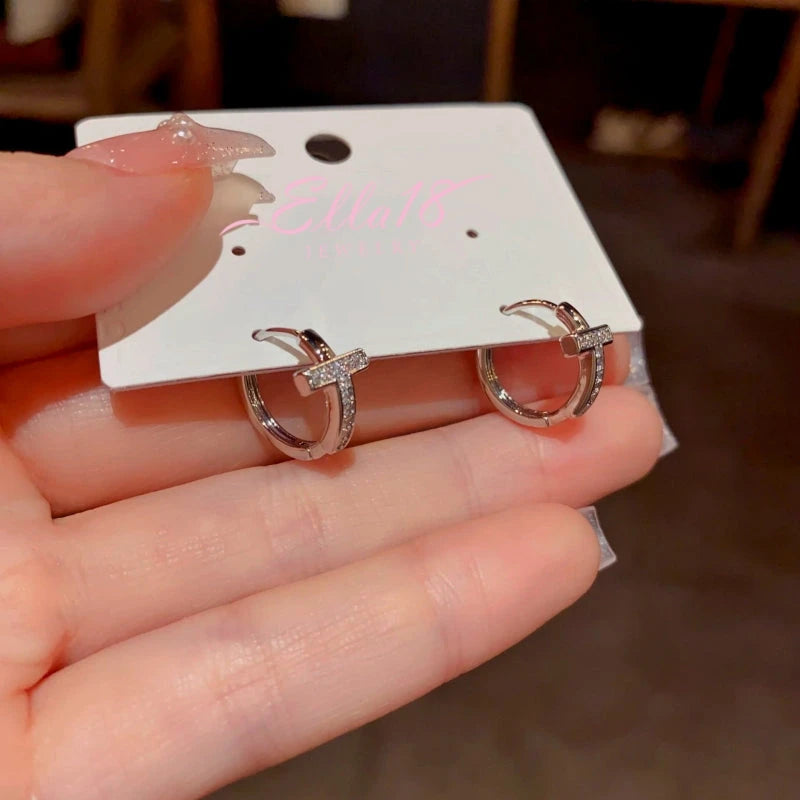 Close-up detail of the sparkling zircons and plating on the Cross Hoop Earrings