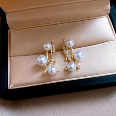 Angled view of the 14K Gold-Plated Zircon Cross Pearl Earrings