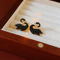 Angled view of the 14K Gold-Plated Zircon Crown Black Swan Earring And Necklace Set