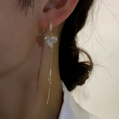 Model showcasing the dangle and style of the 14K Gold-Plated Zircon Crystal Heart Tassel Earrings