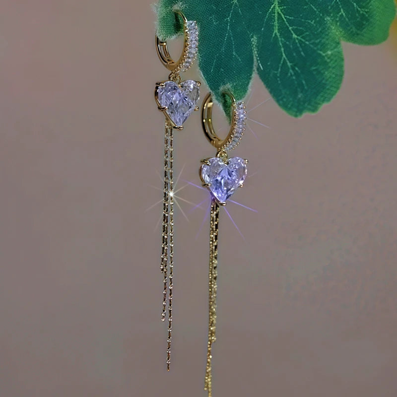 Angled view of the 14K Gold-Plated Zircon Crystal Heart Tassel Earrings