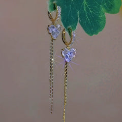 Angled view of the 14K Gold-Plated Zircon Crystal Heart Tassel Earrings