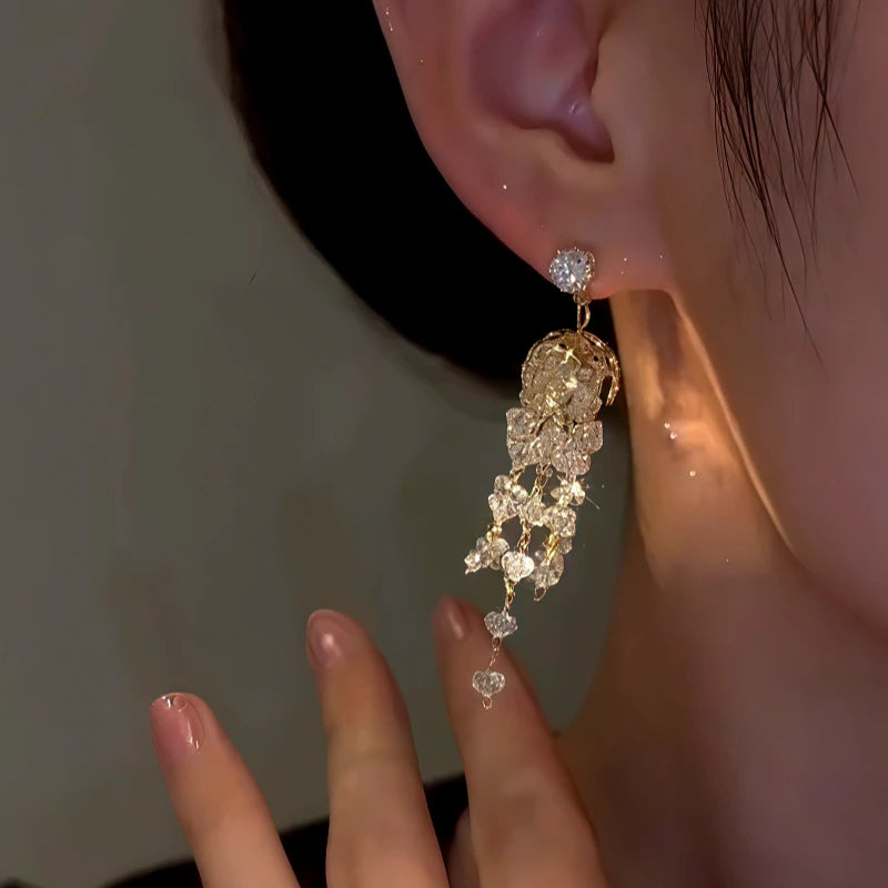 Model showcasing the dangle and style of the 14K Gold-Plated Zircon Crystal jellyfish Tassel Earrings