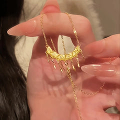 Close-up of the pendant and clasp on the Crescent Tassel Necklace