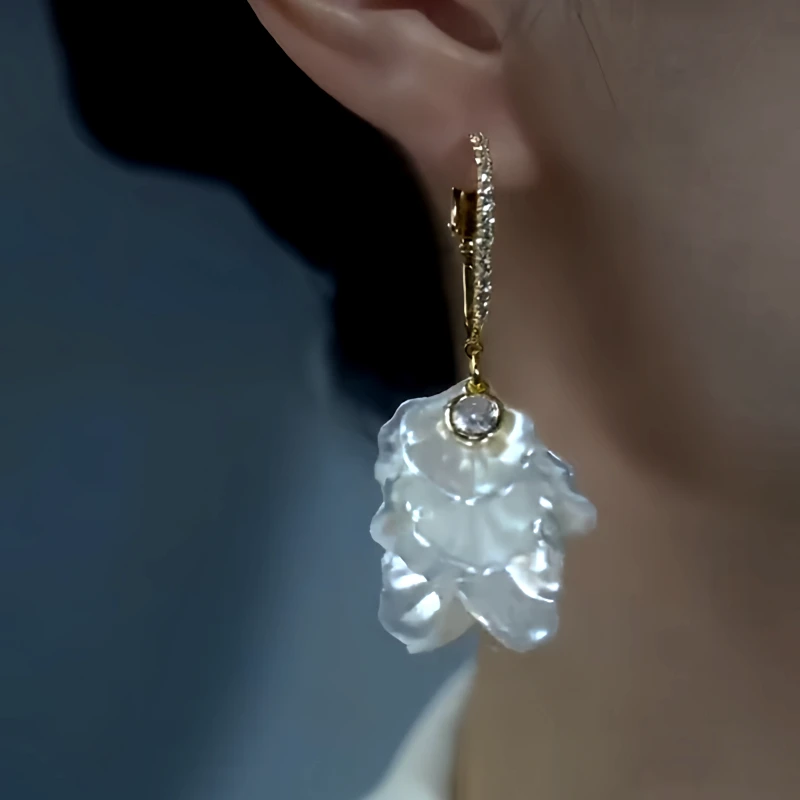Model showcasing the dangle and style of the 14K Gold-Plated Zircon Diamond-Studded White Petal Earrings