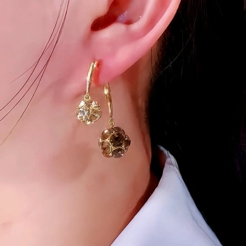 Angled view of the 14K Gold-Plated Zircon Diamond Ball Earrings