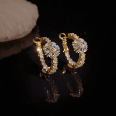 Model showcasing the dangle and style of the 14K Gold-Plated Zircon Diamond Ball Hoop Earrings