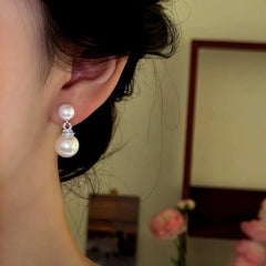 Model showcasing the dangle and style of the 14K Gold-Plated Zircon Diamond Bead Earrings