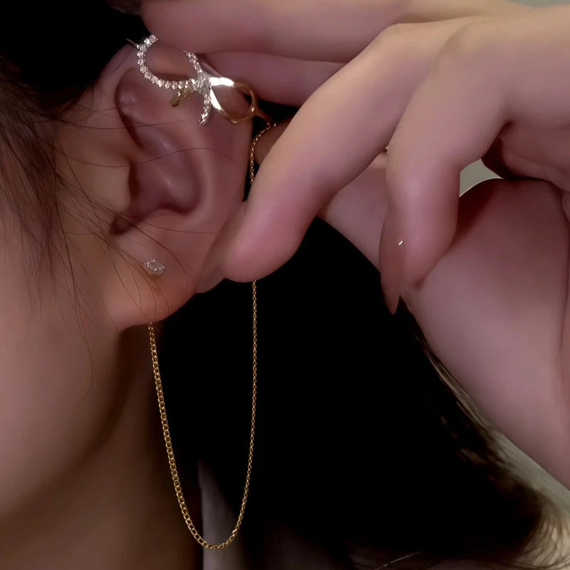 Model showcasing the dangle and style of the 14K Gold-Plated Zircon Diamond Bow Ear Cuff Earrings