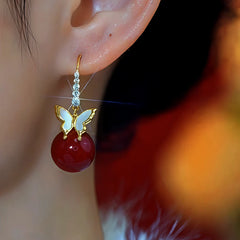 Model showcasing the dangle and style of the 14K Gold-Plated Zircon Diamond Butterfly Bead Ear Hooks