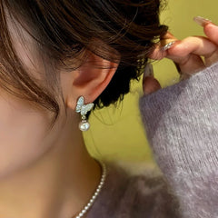 Model showcasing the dangle and style of the 14K Gold-Plated Zircon Diamond Butterfly Bead Earrings
