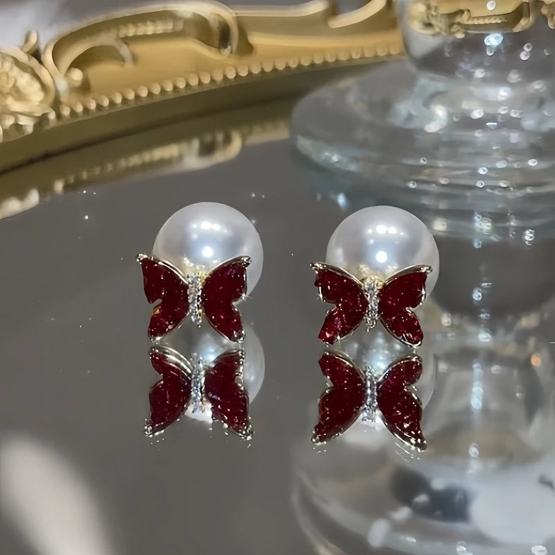 Angled view of the 14K Gold-Plated Zircon Diamond Butterfly Pearl jacket Earrings