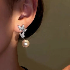 Model showcasing the dangle and style of the 14K Gold-Plated Zircon Diamond Butterfly Tassel Earrings
