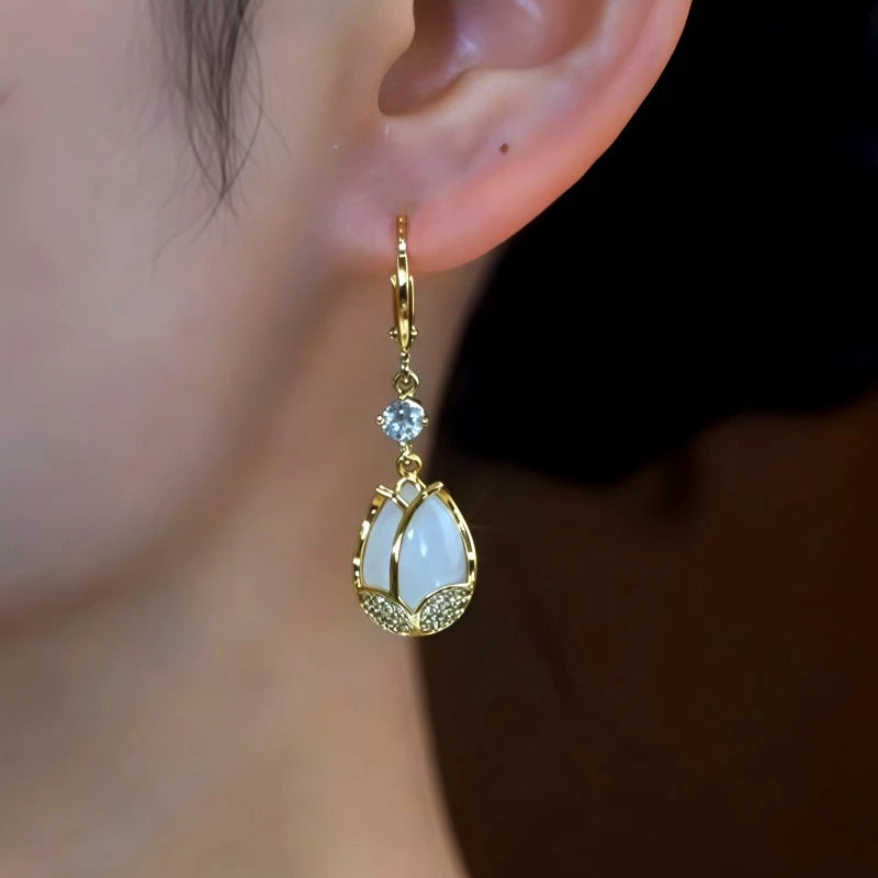Model showcasing the dangle and style of the 14K Gold-Plated Zircon Diamond Cat's Eye Stone Tulip Earrings