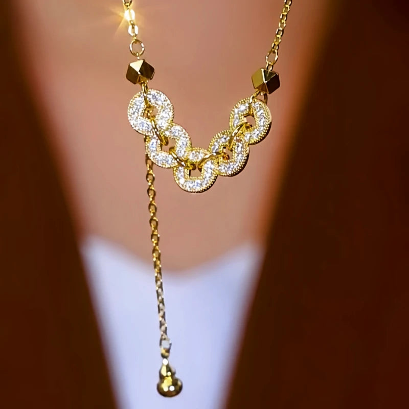 Close-up of the pendant and clasp on the Coin Tassel Necklace