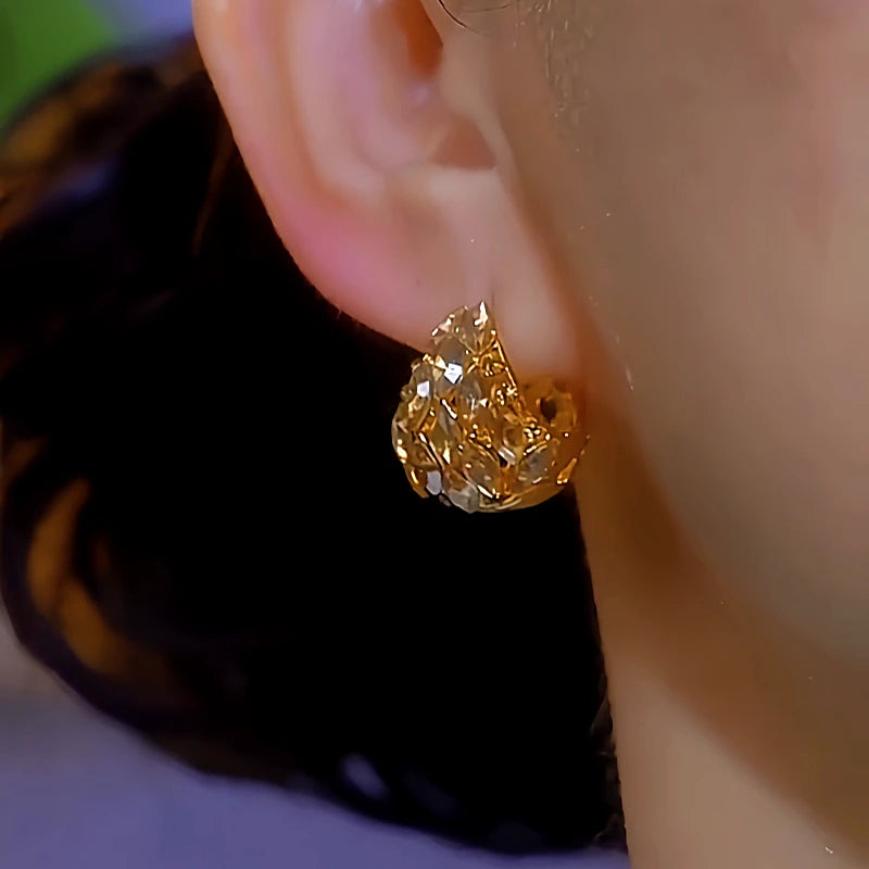 Model showcasing the dangle and style of the 14K Gold-Plated Zircon Diamond Earrings