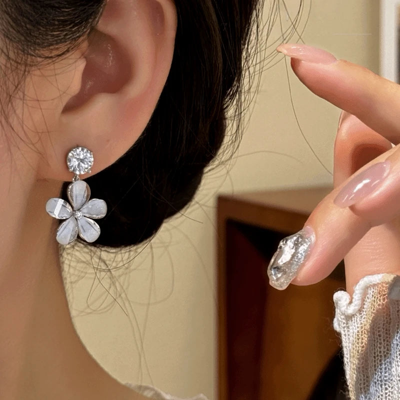 Model showcasing the dangle and style of the 14K Gold-Plated Zircon Diamond Flower Tassel Earrings